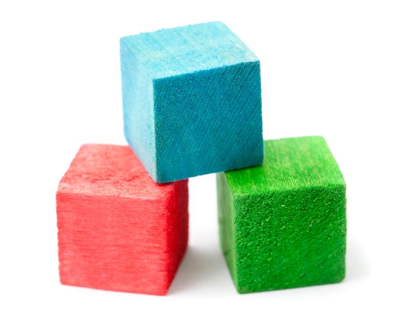 Free Stock Photo: Red, blue and green wooden building blocks, closeup over white background