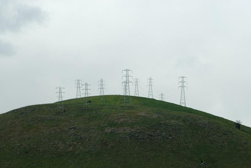 Free Stock Photo: a line of power towers or pylons on top of a hill