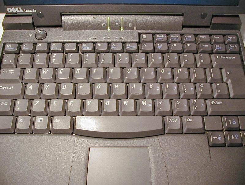 Free Stock Photo: Close up of Dell laptop computer keyboard colored light brown with lighted diodes in the middle