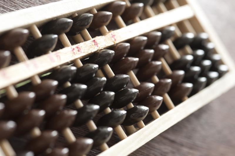 Free Stock Photo: Traditional wooden abacus for manual computing in a close up view with focus to the counters at an oblique angle