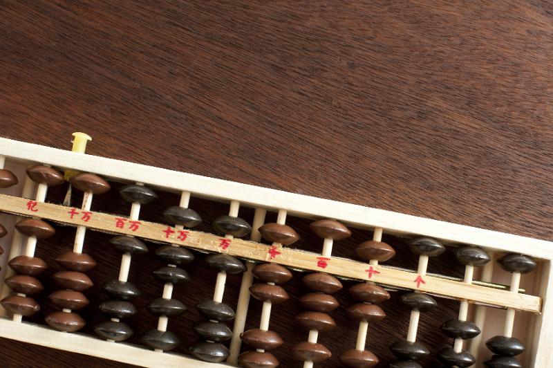 Free Stock Photo: Wooden abacus lying on a desk or table viewed from overhead with copy space in a maths or accounting theme