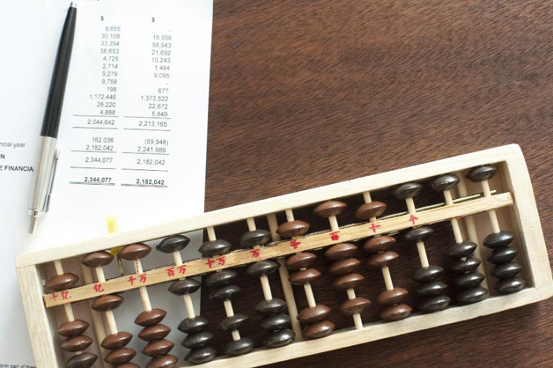 Free Stock Photo: Pen and printed expense report beside wooden abacus over brown table with copy space