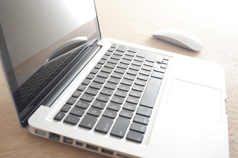 Free Stock Photo: Single open laptop computer with black keys and metallic covering beside wireless mouse on table