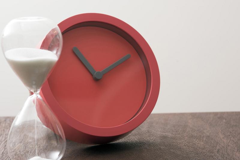 Free Stock Photo: Sand filled hourglass and blank face clock on table with copy space for concept about the passing of time