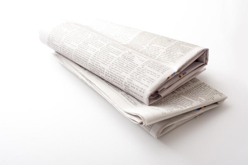Free Stock Photo: Close up of two folded printed newspapers against a white background