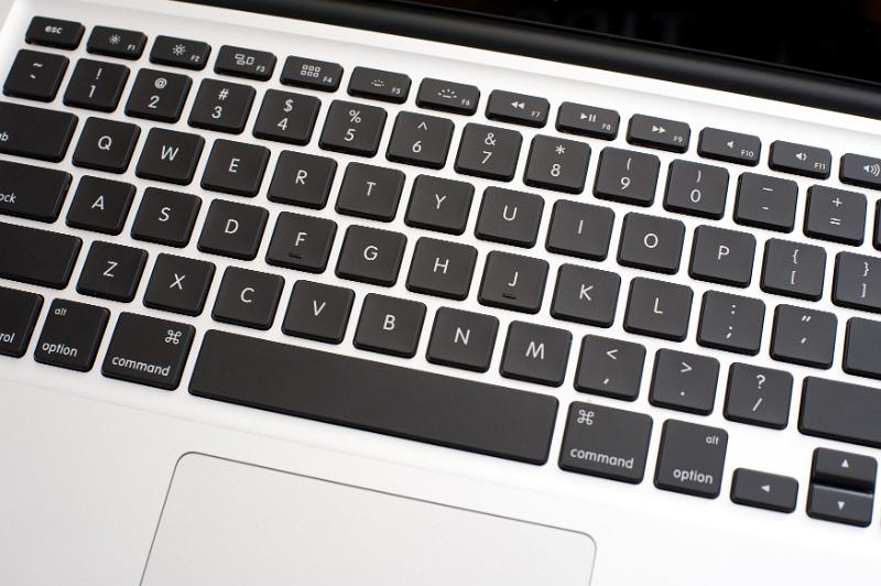 Free Stock Photo: Top down view on a laptop keyboard with black keys showing a portion of the touch pad