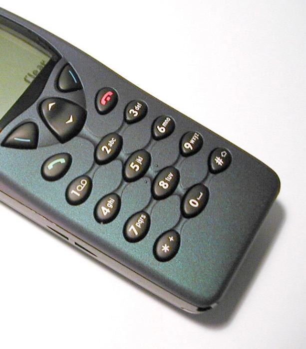 Free Stock Photo: Retro mobile phone with a close up view of the keypad and partial view of the small screen above on white