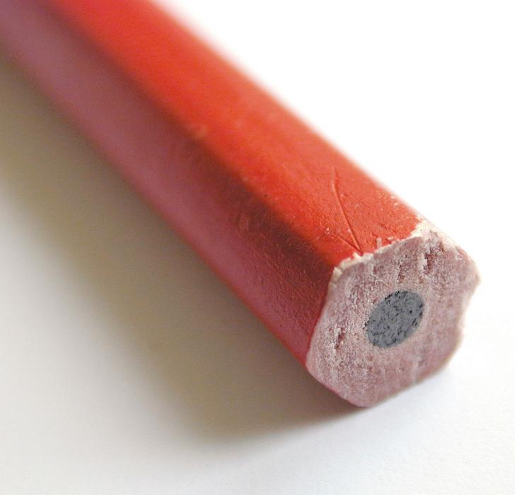 Free Stock Photo: Back end of a red wooden pencil showing the graphite lead in a macro view with selective focus over white