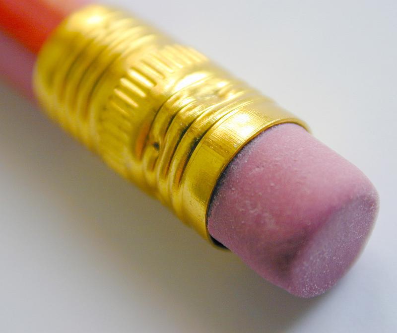 Free Stock Photo: Extreme close up view of an eraser attached to end of a pencil with gold colored metal wrapped to keep it in place
