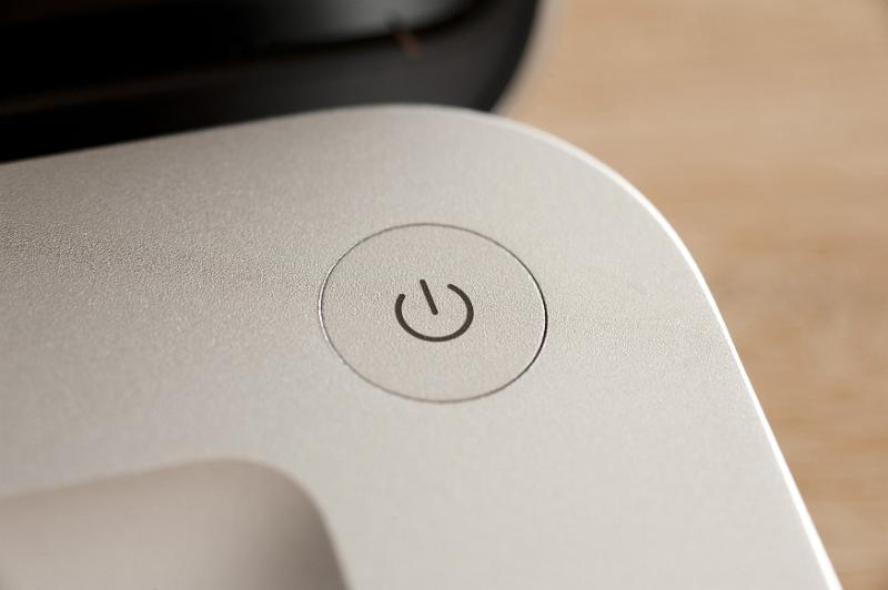 Download image of Power button on a laptop computer Free Stock Photo: Close up of a power button on a laptop computer positioned in the rounded corner, close up view from above
