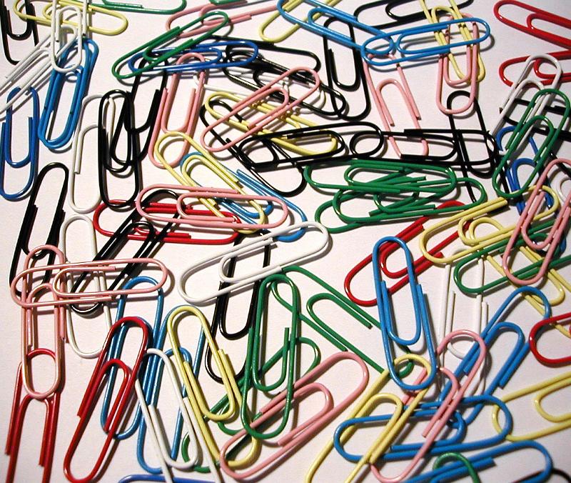 Free Stock Photo: Scattered background of colorful paperclips on a white background viewed from above as a background texture and pattern