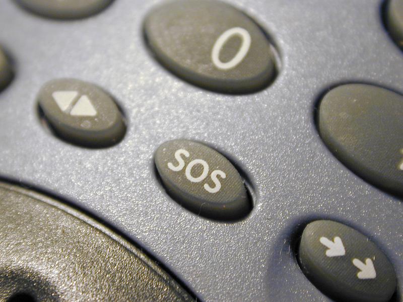Free Stock Photo: Close up on emergency SOS button on blue and black plastic portable radio device