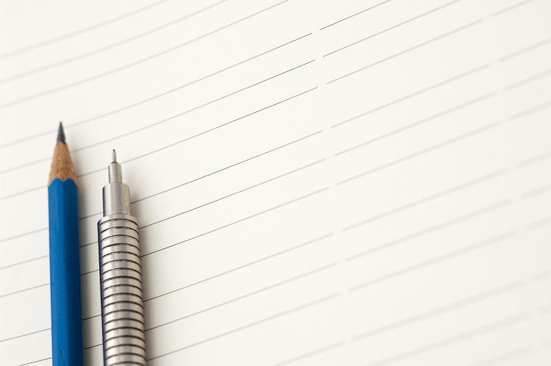 Free Stock Photo: Blank lined page with a metallic silver mechanical pencil and a wooden sharpened pencil ready for you to write your text or message