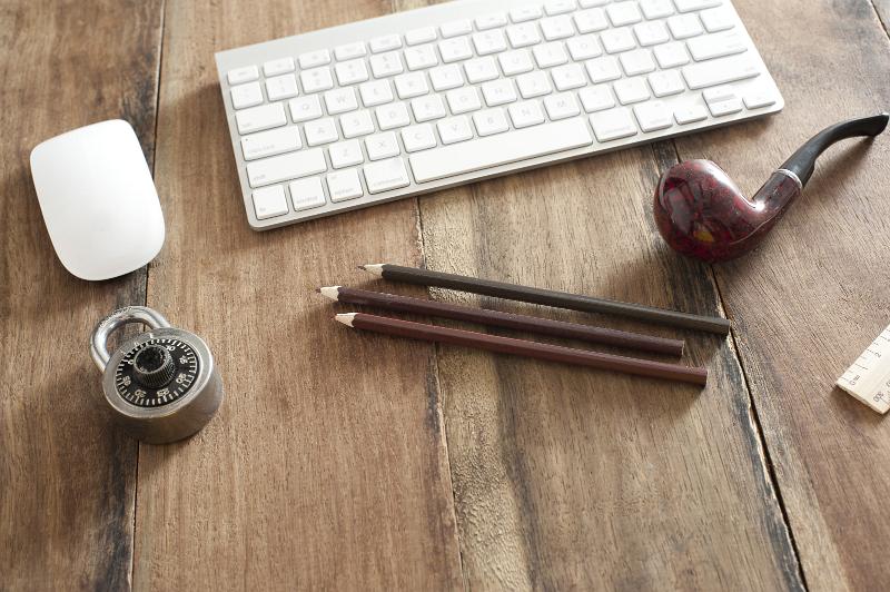 Free Stock Photo: a desk still life with space for text in the foreground with a pipe, security lock, computer keyboard and mouse in the background