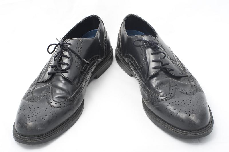 Free Stock Photo: Smart black leather business shoes with a punched pattern for the fashionable man on white