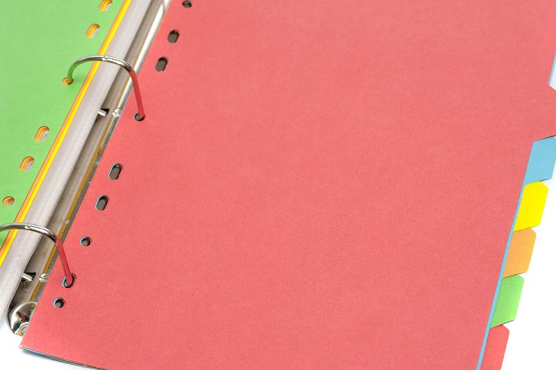 Free Stock Photo: Open red ring file with tabbed multicolour cardboard index inserts for sorting and filing the contents