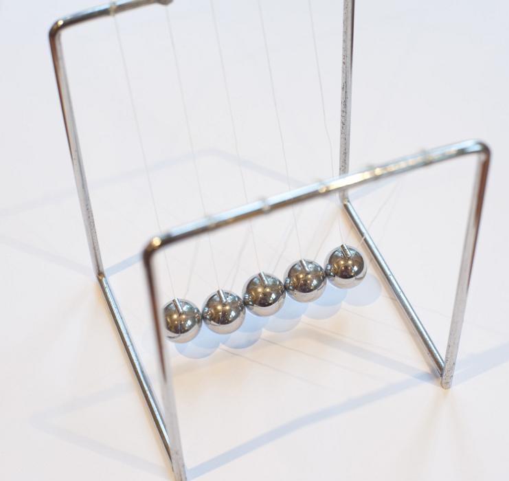 Free Stock Photo: Newton's cradle executive toy with five suspended metal balls to show the conservation of energy and motion