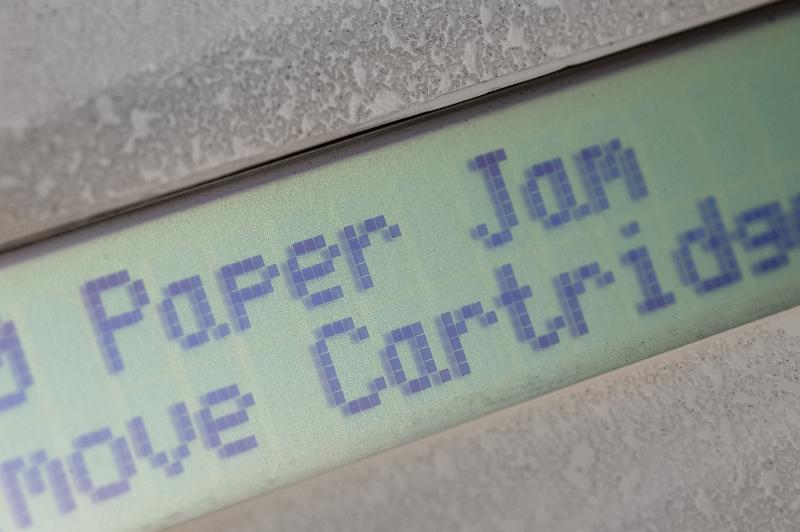 Free Stock Photo: Close up view of a printer warning for a paper jam. The message tells how to remove the paper jam.