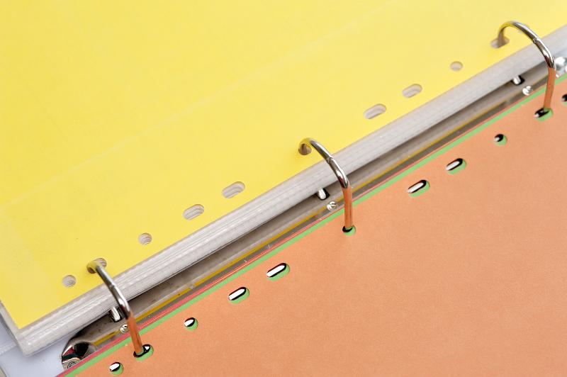 Free Stock Photo: Three ring binder open to the center between yellow and brown tabbed dividers