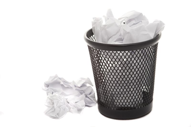 Free Stock Photo: wastepaper basket called a wastebin in other parts of the world filled with crumpled paper and some on the floor