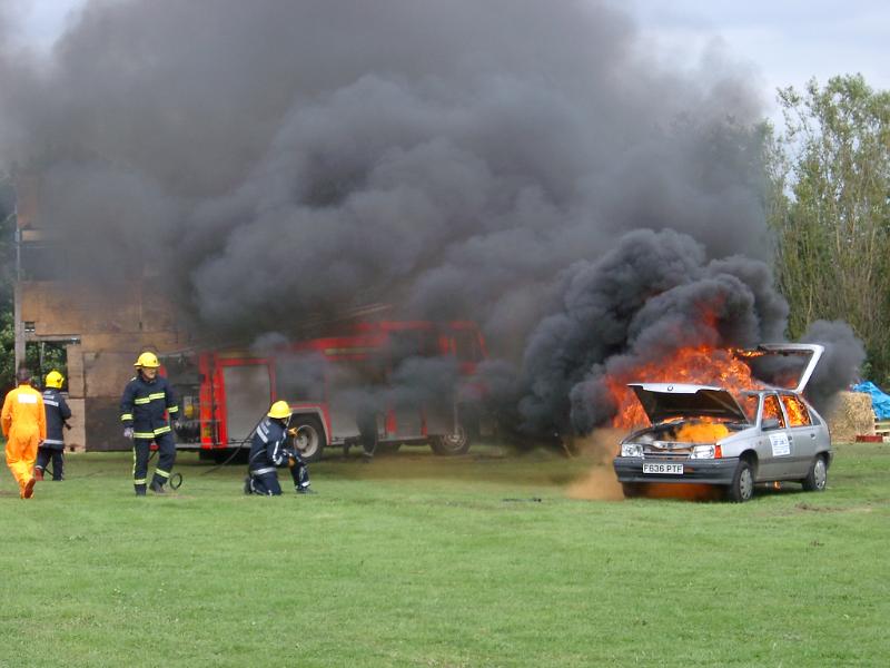 Free Stock Photo: fire fighters attending to a demonstration car fire