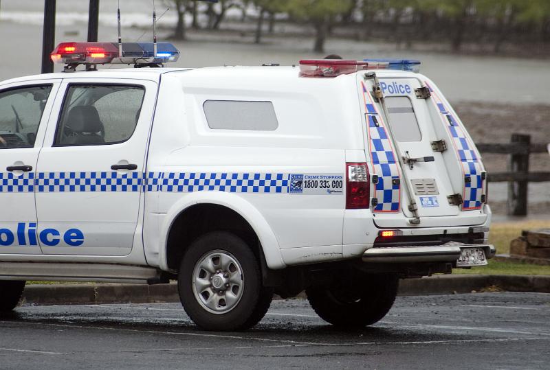 Free Stock Photo: Rear end of a police van showing the typical blue and white markings parked in a parking lot