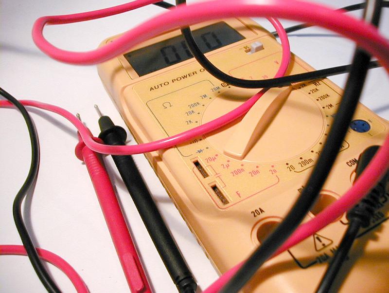 Free Stock Photo: Close Up of Yellow Multimeter with Jumbled Red and Black Test Lead Cords on White Background