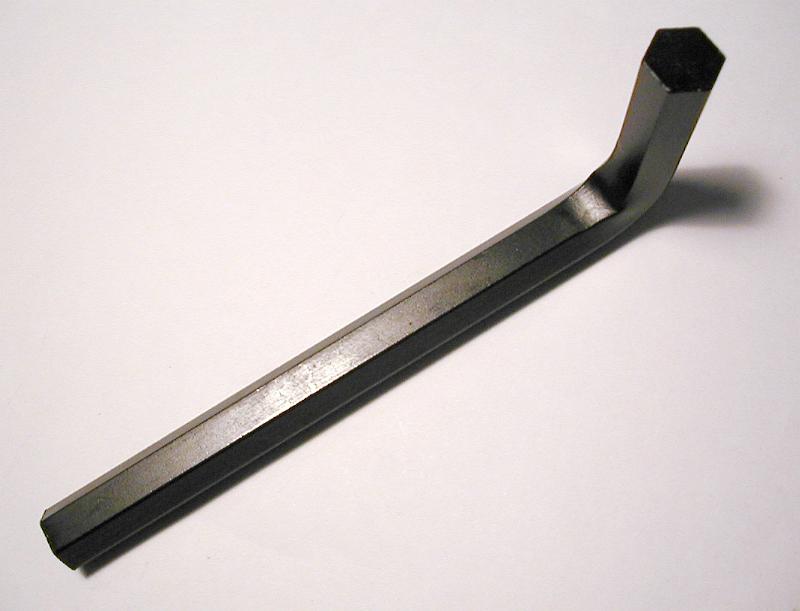 Free Stock Photo: Metallic black L-shaped tool used to work with hexagonal screws, close-up with shadow and copy space on gray