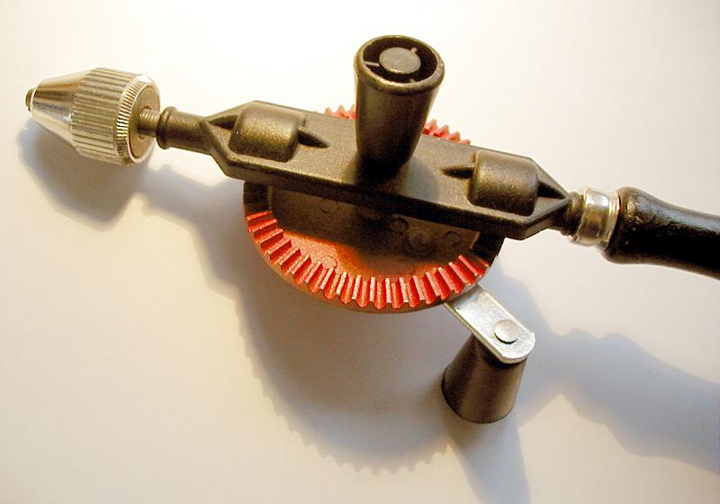 Free Stock Photo: Close Up Detail of Old Fashioned Handheld Drill Angled on White Background