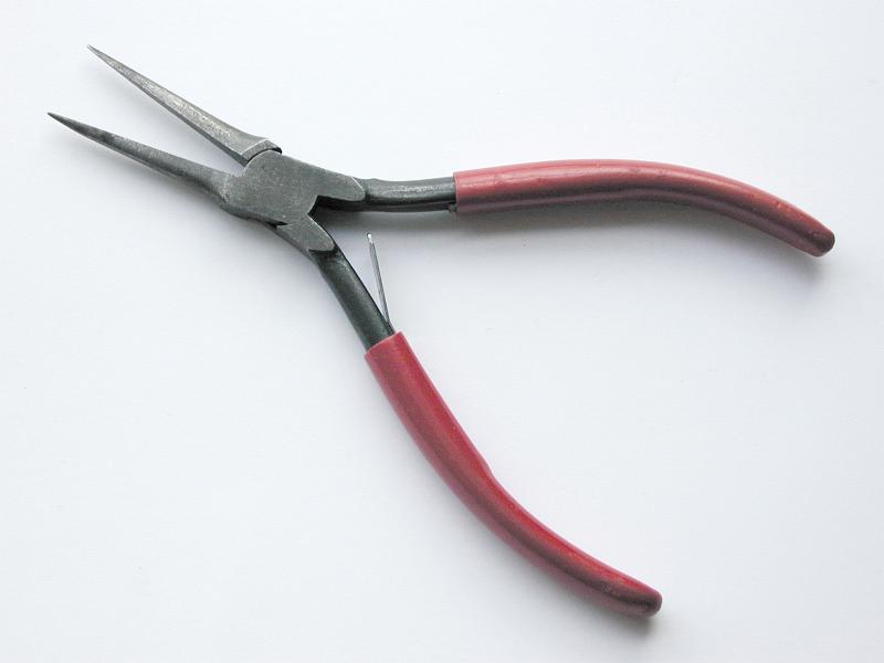 Free Stock Photo: High Angle of Needle Nosed Pliers with Red Handles Angled on White Background