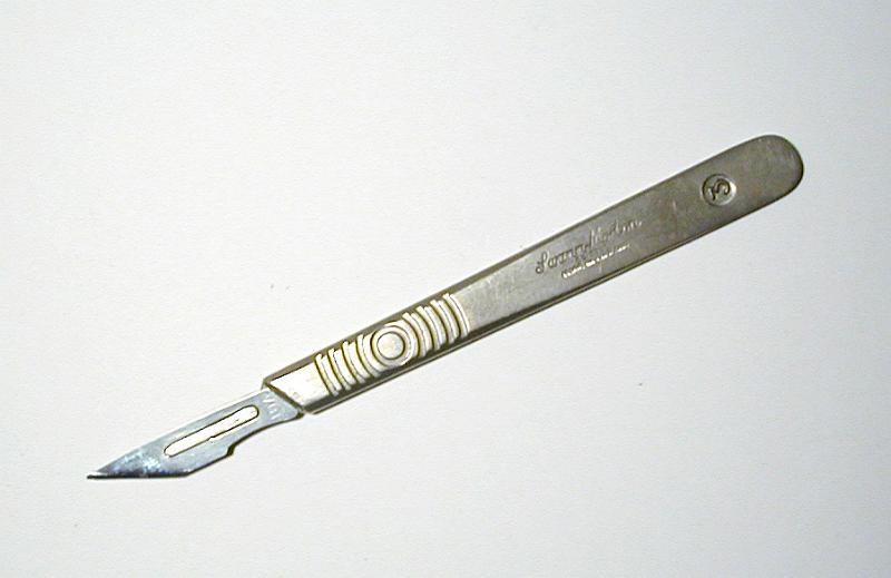 Free Stock Photo: Still Life of Angled Silver Scalpel Blade on White Background