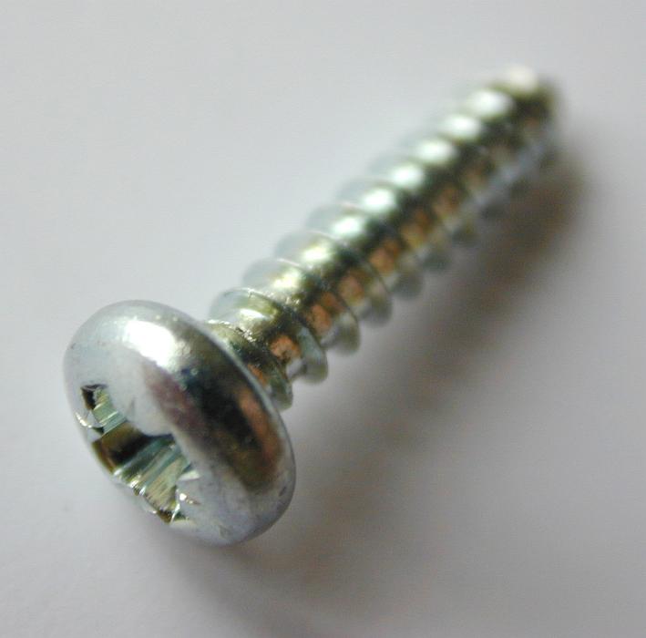Free Stock Photo: Close Up of Single Silver Colored Metal Phillips Drive Screw Angled on White Background